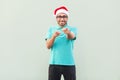 Hey you! Its christmas man! Bearded man in santa hat and glasses Royalty Free Stock Photo