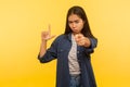 Hey you loser! Portrait of girl in denim shirt making, L sign and pointing to camera saying you lost, accusing for failure Royalty Free Stock Photo