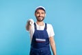 Hey you! Portrait of happy handyman in overalls and gloves, pointing finger to camera. Profession of service industry Royalty Free Stock Photo