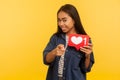 Hey you! Portrait of playful girl in denim shirt pointing to camera and showing heart Like icon, follower notification