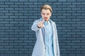 Hey you. Portrait of serious or anger handsome young blonde man in casual style standing, pointing and looking at camera with Royalty Free Stock Photo