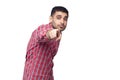 Hey you. Portrait of shocked handsome bearded young businessman in red checkered shirt standing pointing and looking at camera Royalty Free Stock Photo