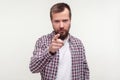 Hey you! Portrait of strict bossy bearded man pointing warning finger at camera. isolated on white background