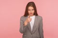 Hey you! Portrait of strict displeased young woman in business suit making choice with indicating finger Royalty Free Stock Photo