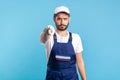 Hey you! Portrait of strict handyman in overalls and cap pointing finger to camera. Profession of service industry Royalty Free Stock Photo