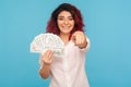 Hey you, start business, earn big money! Charming happy businesswoman with fancy red hair in white shirt holding dollar banknotes