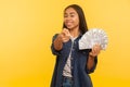 Hey you, want big profit? Portrait of rich happy satisfied woman holding dollar banknotes and pointing to camera