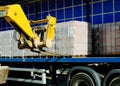 HGV delivered concrete blocks on construction site and telehandler offloading it Royalty Free Stock Photo