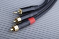 Hi-Fi RCA gold audio cable on grey background Royalty Free Stock Photo