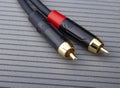 Hi-Fi RCA gold audio cable on grey background Royalty Free Stock Photo