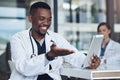 Hi how are you. a young male doctor taking a break and using his digital tablet. Royalty Free Stock Photo