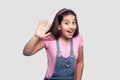 Hi. Portrait of surprised beautiful brunette young girl in casual pink t-shirt and blue overalls standing with amazed face and Royalty Free Stock Photo