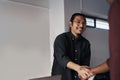 Hi, welcome. two young businessmen greeting each other with a handshake before sitting down in the office.