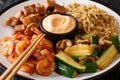 Hibachi dish consisting of fried rice with egg, shrimp, steak and vegetables served with sauce closeup in a plate. horizontal Royalty Free Stock Photo