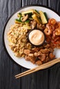 Hibachi fried rice with egg, shrimp, steak and vegetables close-up in a plate. Vertical top view Royalty Free Stock Photo