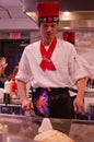 Hibachi restaurant chef preparing meal and entertaining guests