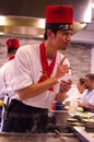 Hibachi restaurant chef preparing meal and taking order and entertaining guests