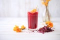 hibiscus agua fresca in a glass, with dried hibiscus flowers beside