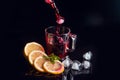 Hibiscus cold tea pouring into glass with ice, lemon and mint isolated on black background Royalty Free Stock Photo