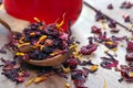 Hibiscus with flower petals and dried fruits in a wooden spoon. cup of fresh hibiscus tea. vitamin tea for health. close up Royalty Free Stock Photo