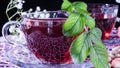 Hibiscus red tea mug with tea leaf or mint leaf close-up horizontal photo.Medicinal therapy on medicinal herbs and decoctions. Royalty Free Stock Photo