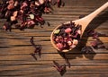 Hibiscus tea. Dry mix of red herbal and fruit tea over wooden surface Royalty Free Stock Photo
