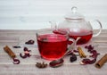 Hibiscus tea in glass teapot, cap with tea, spices and dry flower