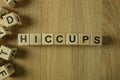 Hiccups word from wooden blocks Royalty Free Stock Photo
