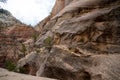 Hidden Canyon trail hike in Zion National Park on an overcast summer day. The hike features steep drop offs with chains