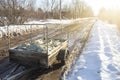 Hidden cargo in plastic bags in the trailer of a passenger car, on a broken country road in the spring, the foreground and