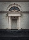 Hidden door in the wall. Doorway camouflage, covered with limestone masonry. Fake entry in the building Royalty Free Stock Photo