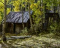 Hidden Historic Abandoned Home with Out House from the Wild West in Fall Royalty Free Stock Photo