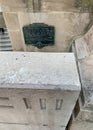 Hidden location of a plate commemorating the First Post Office in Chicago, behind a wall with III to indicate the 3 Forks of the