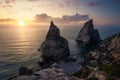 Hidden Praia Da Ursa - Ursa Beach, Sintra, Portugal. Two huge rocks rasing in evening golden sunset light at Atlantic Royalty Free Stock Photo