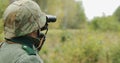 Hidden Re-enactor Dressed As German Wehrmacht Infantry Soldier In World War II Soldier Sitting In Ambush In Autumn