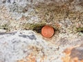 Hidden two euro cent coin in hole of sandstone Royalty Free Stock Photo