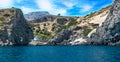 Hidden white and blue chapel near sea under cliff, RHODES, GREE