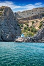 Hidden white and blue chapel near sea under cliff, RHODES, GREE