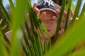 Hidding behind the green leaves