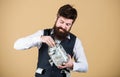 Hiding money for future use. Bearded man investing money from glass jar for future profits. Businessman focusing on