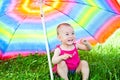 Hiding under a colorful umbrella Royalty Free Stock Photo