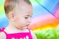 Hiding under a colorful umbrella Royalty Free Stock Photo