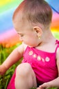 Hiding under a colorful umbrella Royalty Free Stock Photo