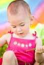 Hiding under a colorful umbrella Royalty Free Stock Photo