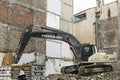 Hidromek HMK 300 excavator standing on a destroyed building