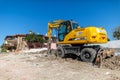 Hidromek hmk 140w excavator stands on a demolished building in antalya