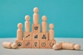 Hierarchical system. Leadership and teamwork. Command chain. Team competition. Wooden people on pyramid steps, on floor Royalty Free Stock Photo