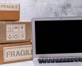 Hig angle shot of fragile box with laptop placed on marble surface