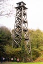 High abandoned wooden tower among trees