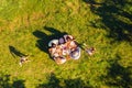 High above angle view big full family having picnic outside cheerful on holidays children playing running around Royalty Free Stock Photo